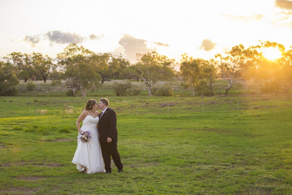 Wedding Photography couple in field at sunset