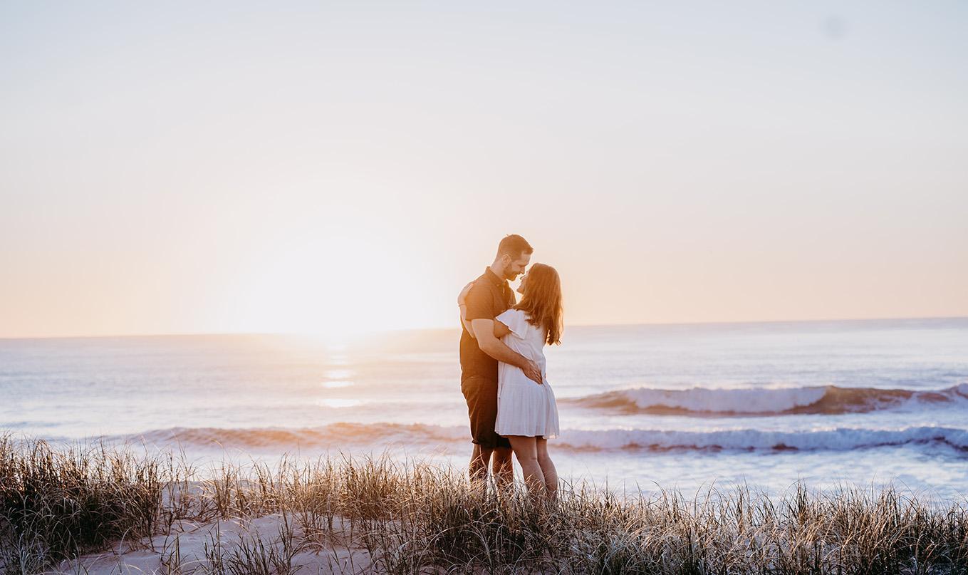 Engagement Photography - couple embracing on beach at sunset