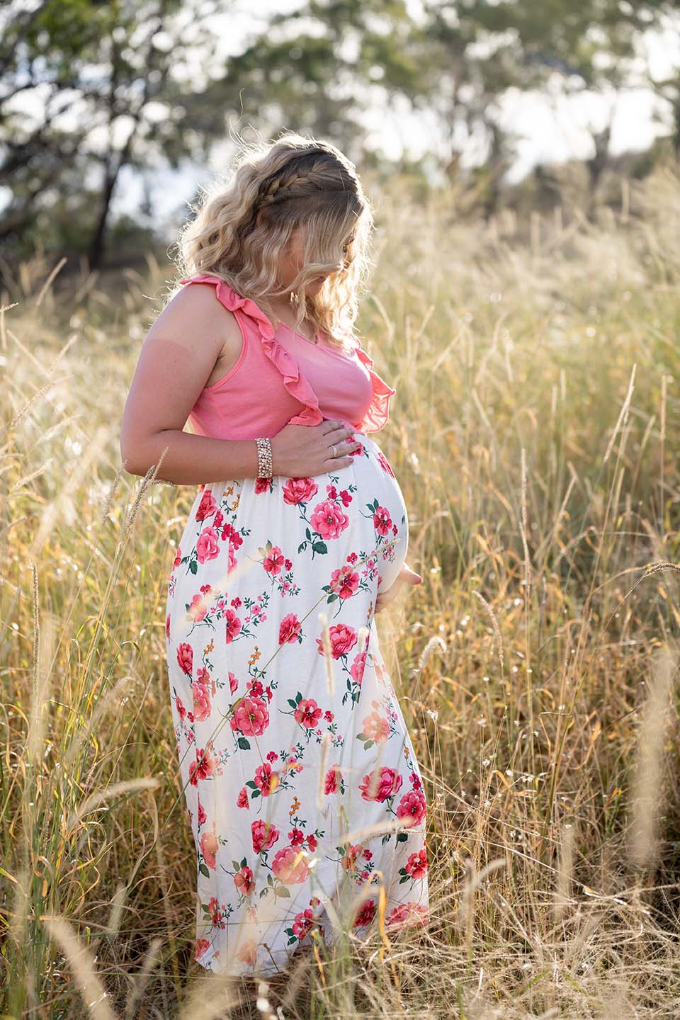 Maternity Photography - Mother holding belly in field
