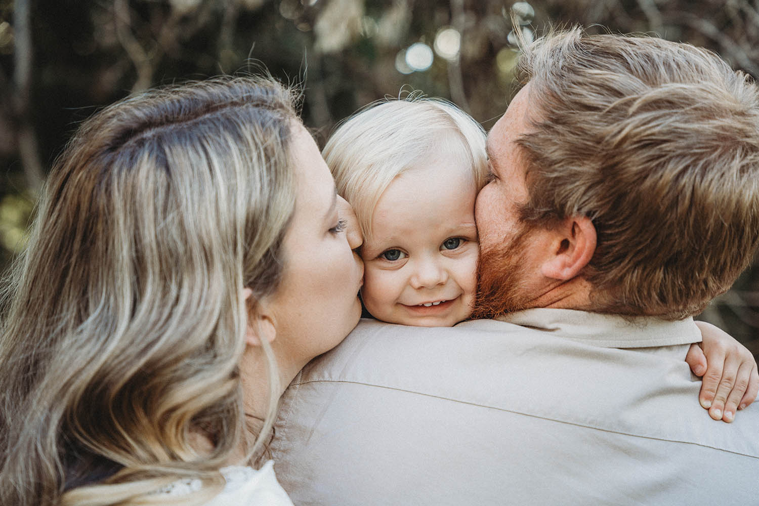 Family Photography - mother and father kissing sons cheek
