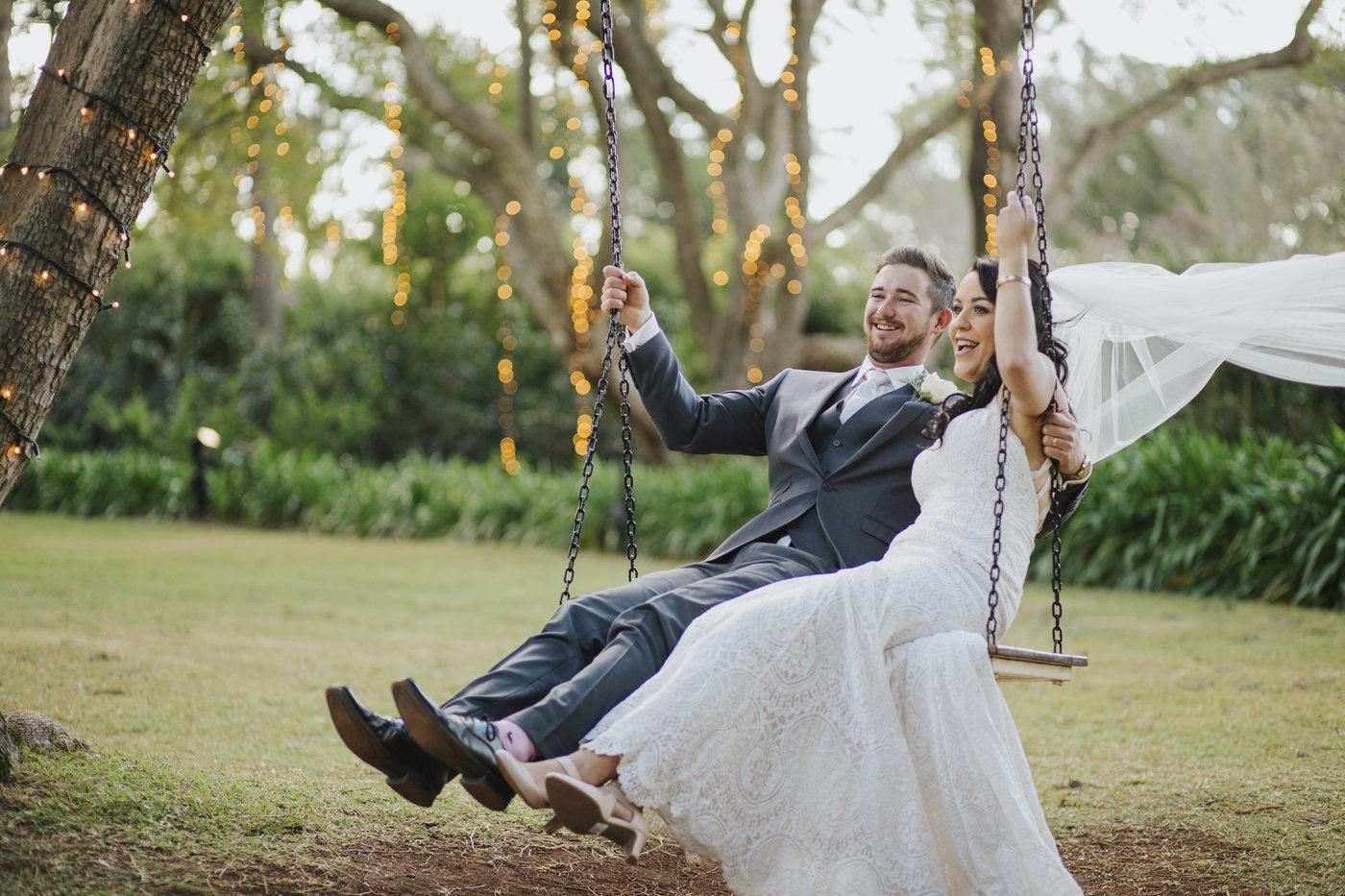 Wedding Photography couple swinging on swing