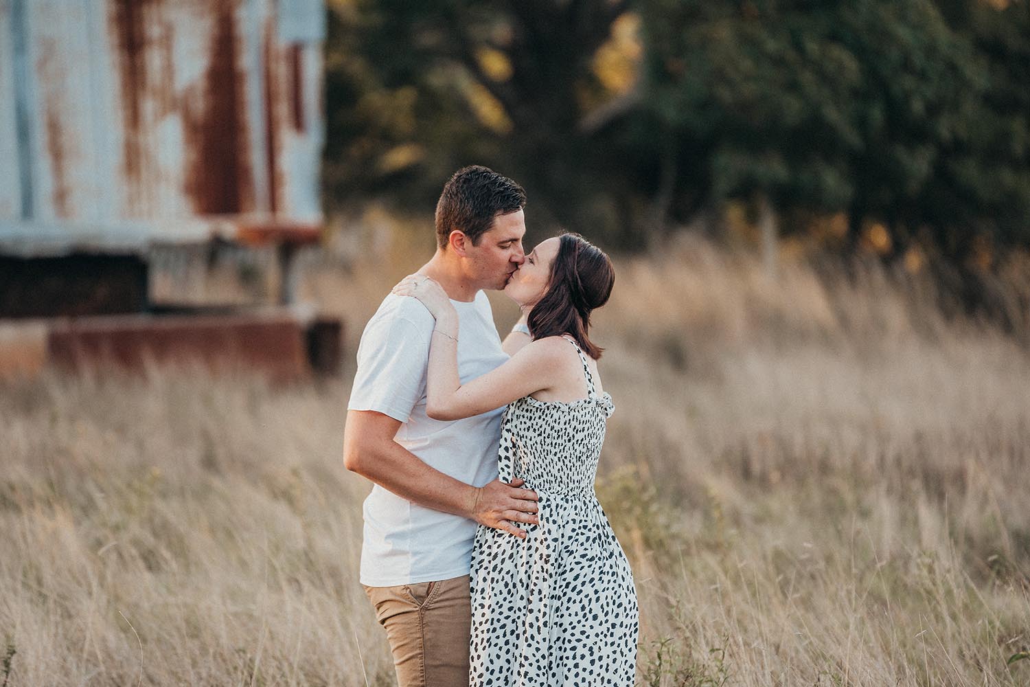 Maternity Photography - Kissing in field