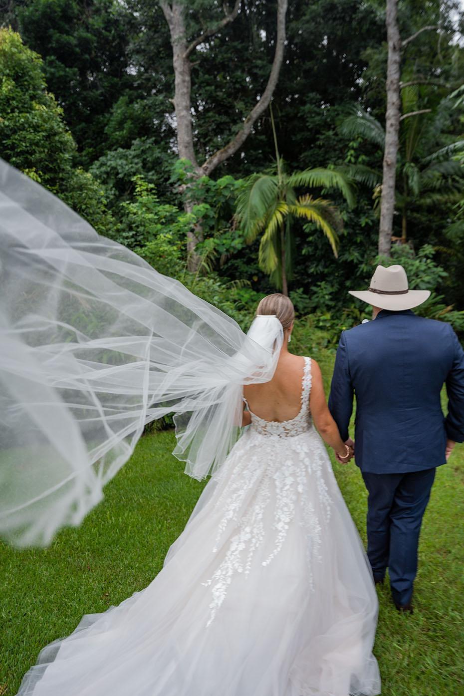 Wedding Photography - Flowing Veil as couple walks away
