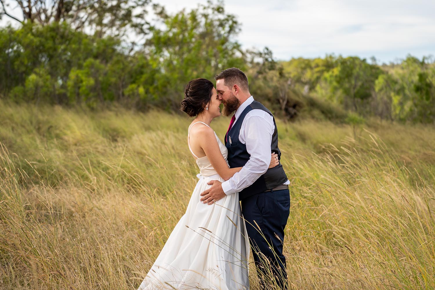 Wedding Photography - couple embracing in field