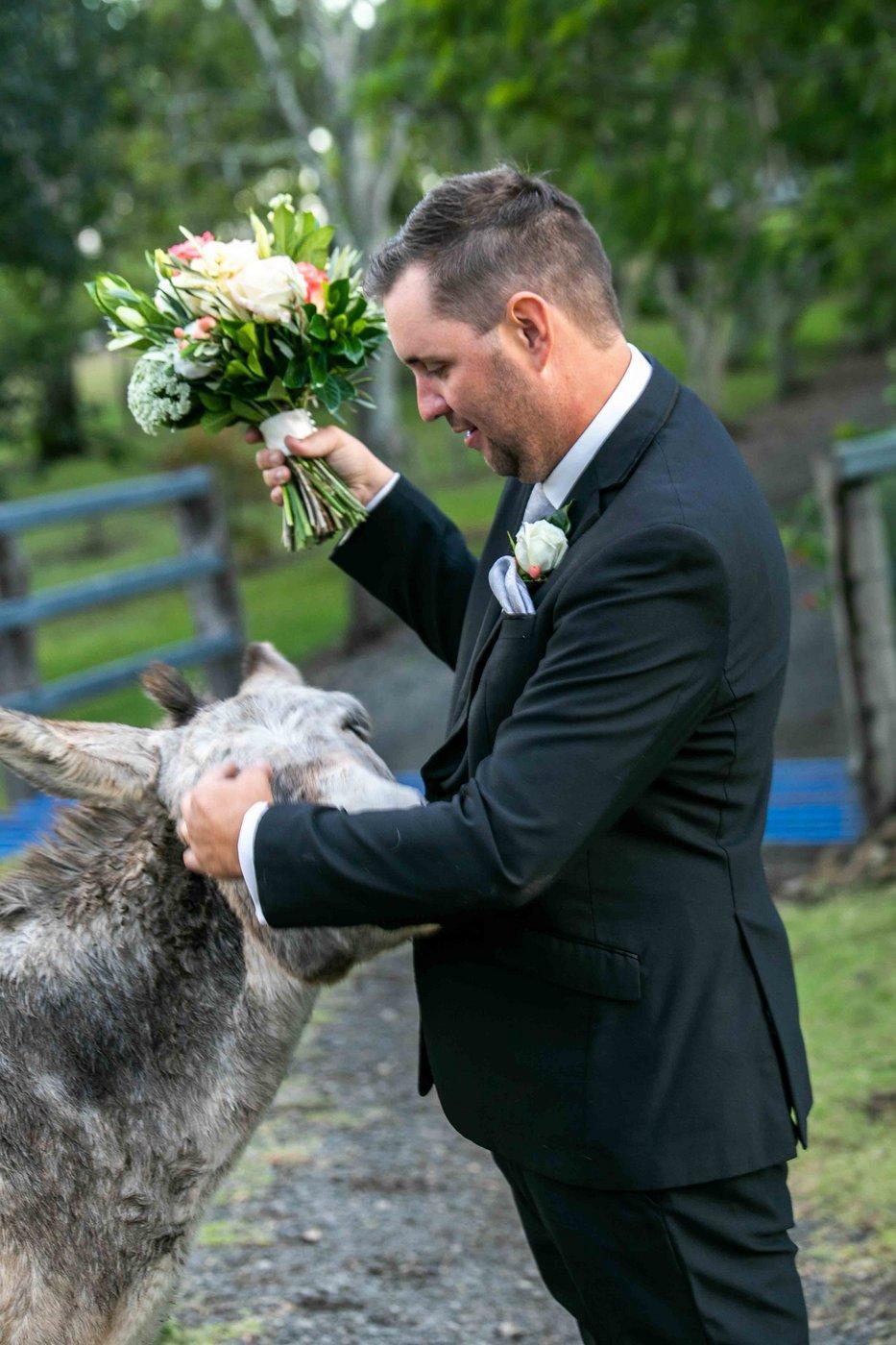 Wedding Photography best man with flowers & donkey