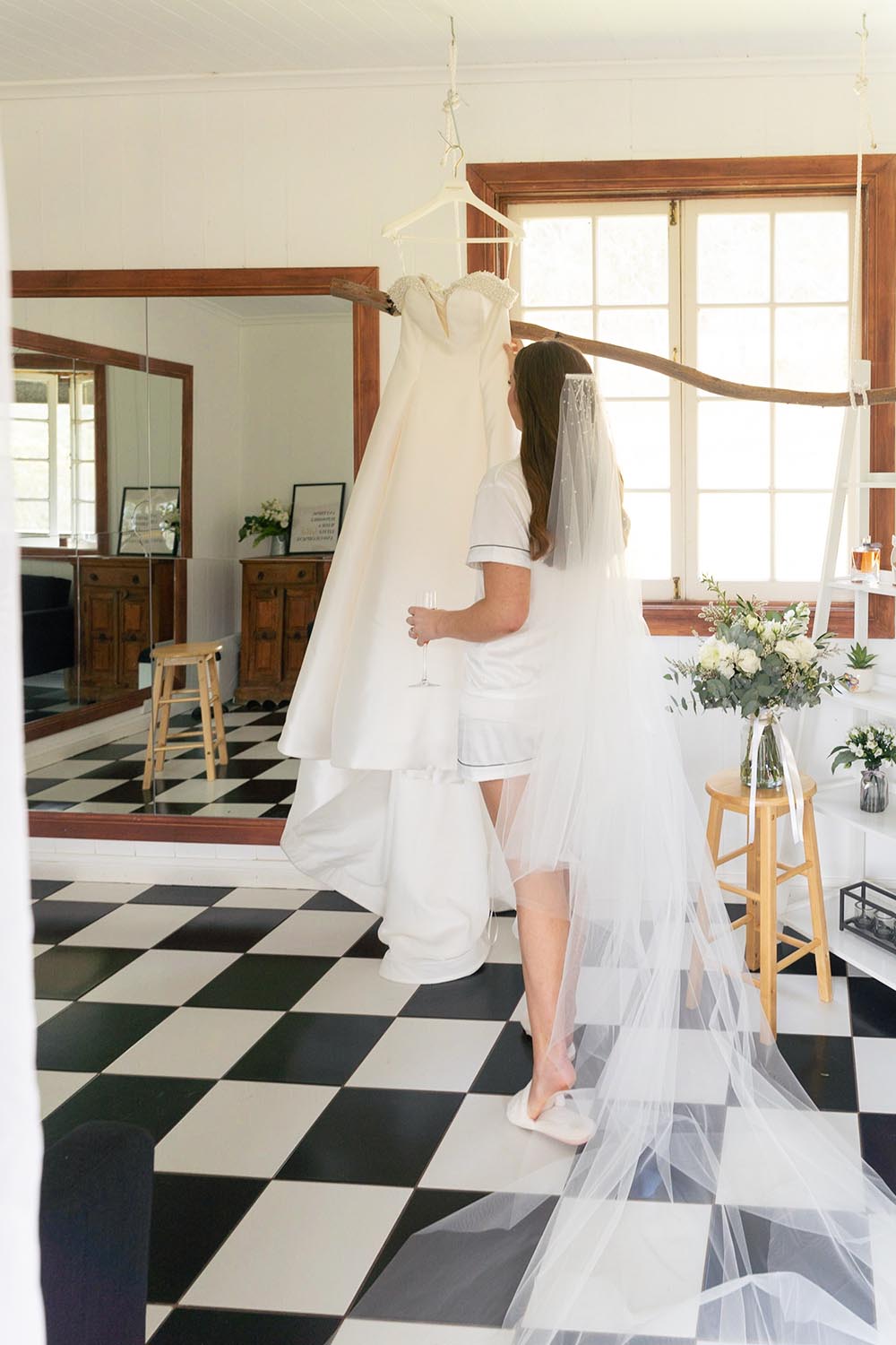 Wedding Photography - bride looking at dress