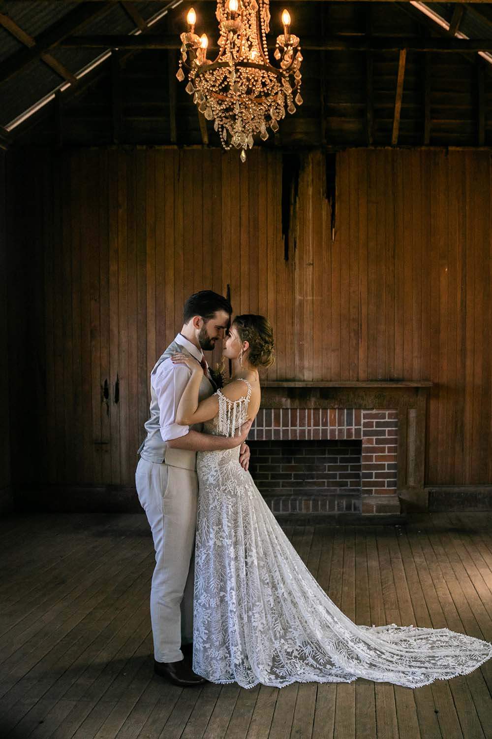 Wedding Photography - Couple embracing in rustic shed
