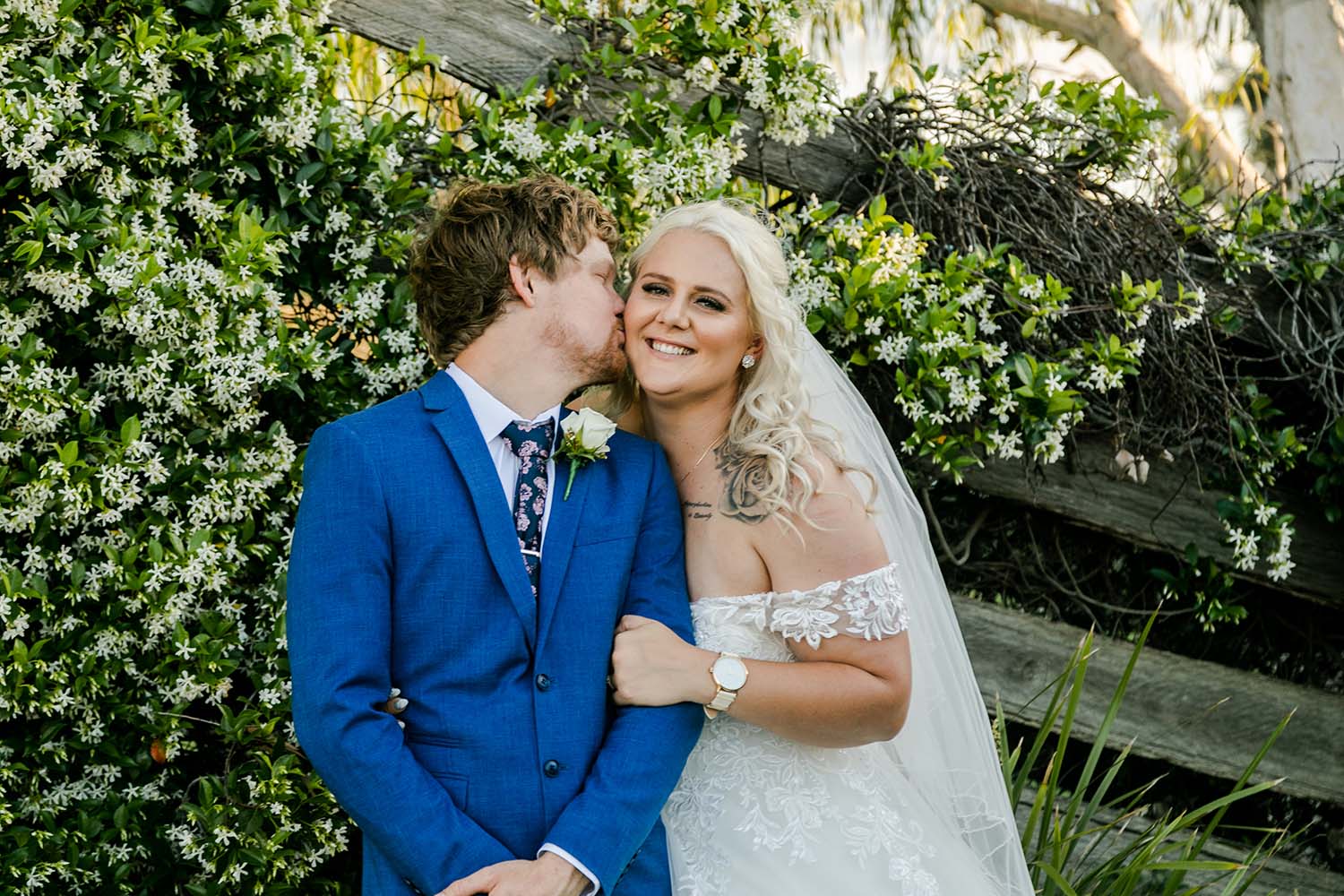 Wedding Photography - Groom kissing bride on cheek