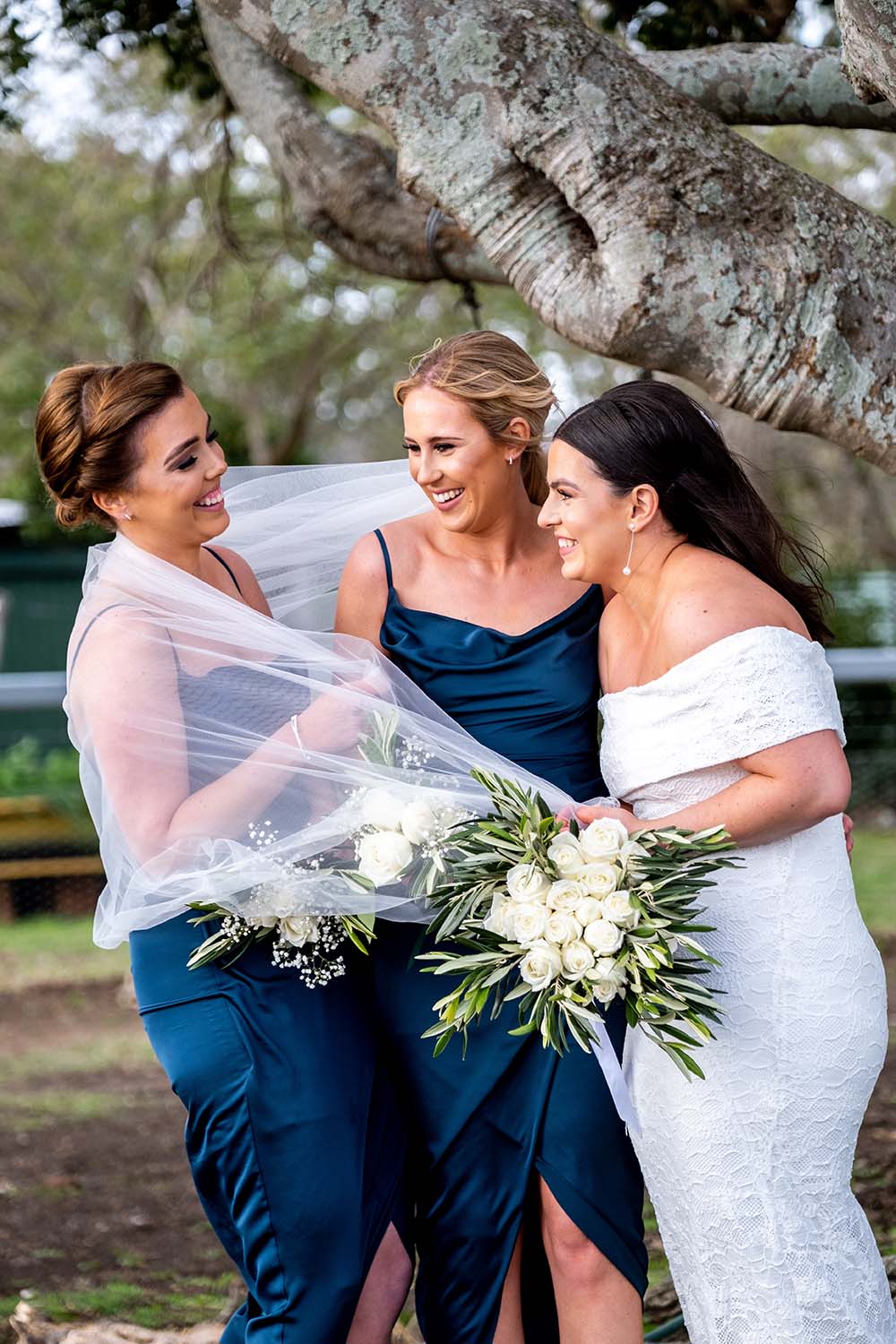 Wedding Photography - Bridesmaids wrapped in brides veil
