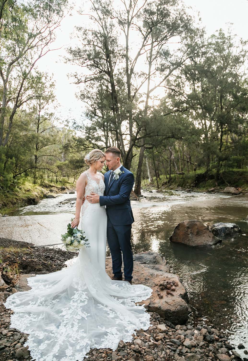 Wedding Photography - couple embracing near stream