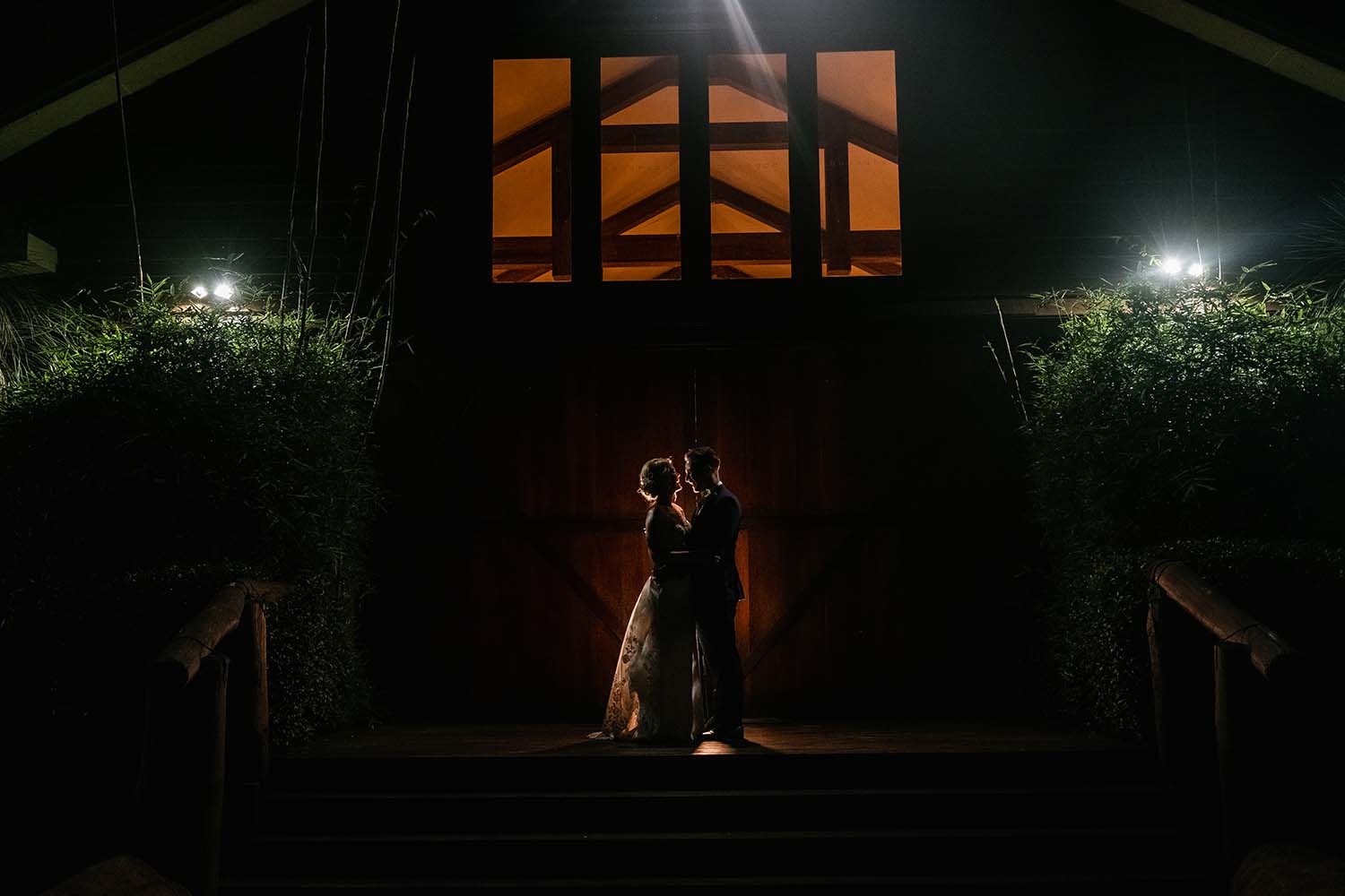 Wedding Photography - couple in front of barn at night