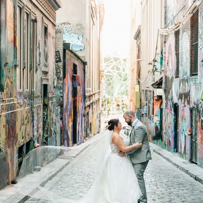 Destination Wedding Photography - Bride and Groom Embrace in Alley