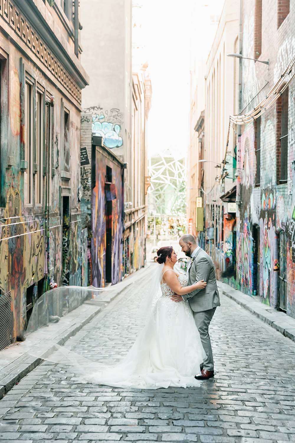 Destination Wedding Photography - Bride and Groom Embrace in Alley