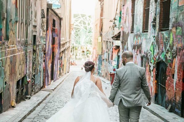 Destination Wedding Photography - Bride and Groom Walking away in Alley