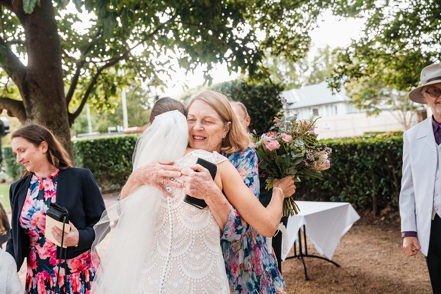 Wedding Photography - Bride hugging guest