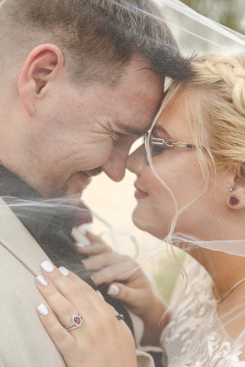 Destination Wedding Photography - Couple embracing under veil