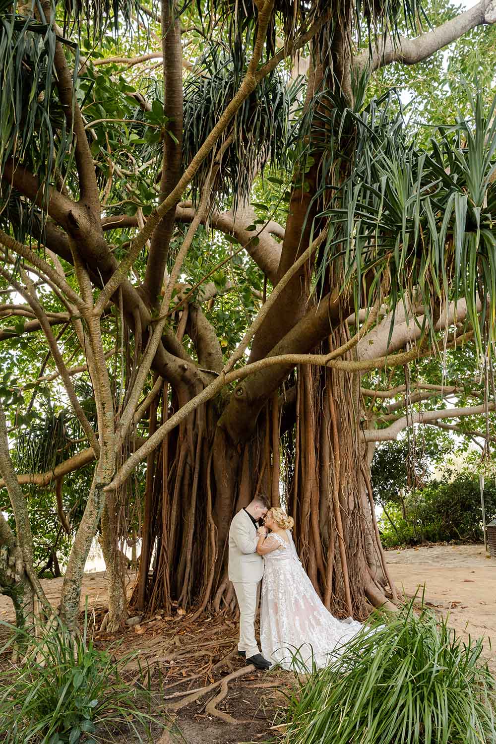 Destination Wedding Photography - bride and groom embracing under tree