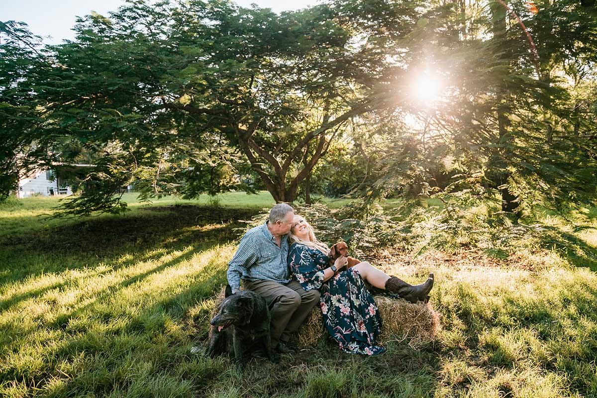 Engagement Photography - couple sitting in field