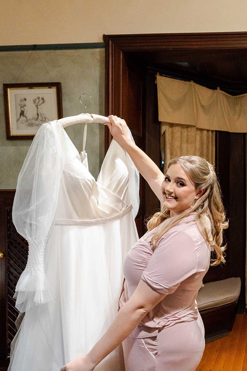 Wedding Photography - Bride holding dress