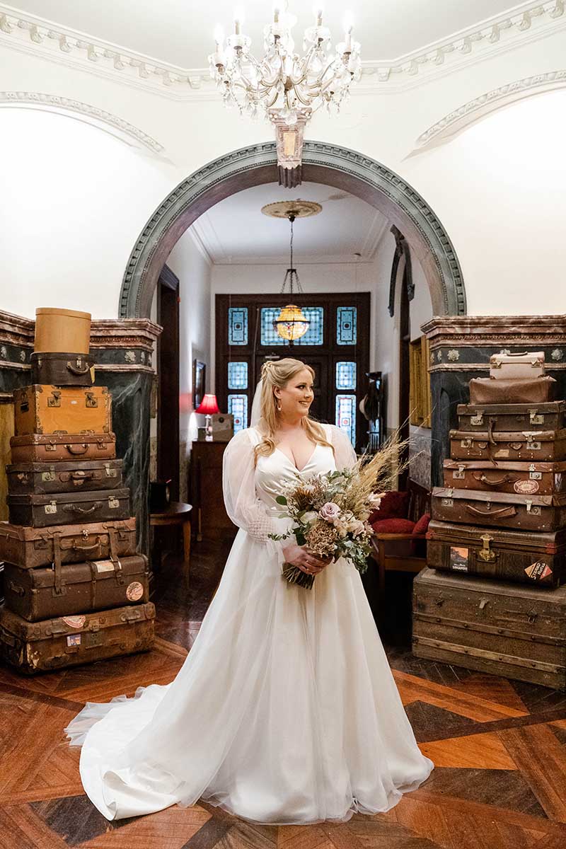 Wedding Photography - Bride in front of rustic suitcases