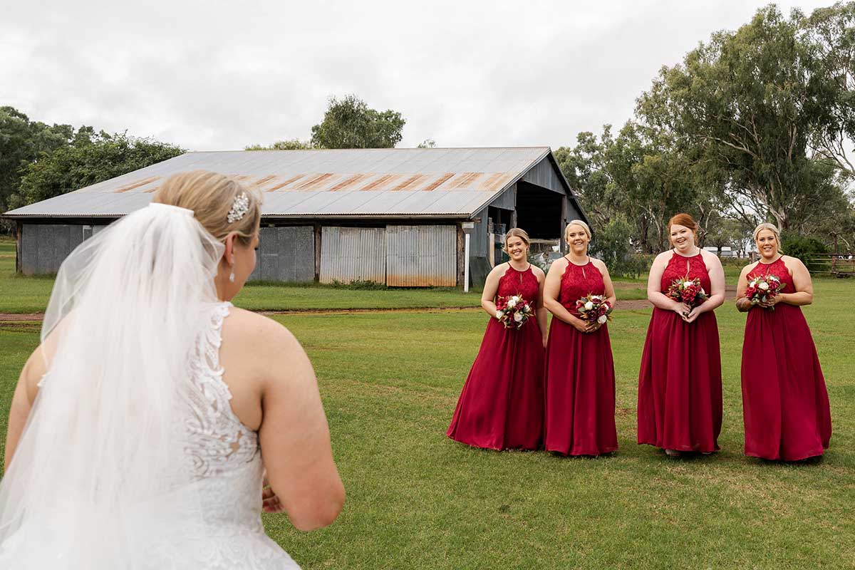 Wedding Photography - Bride standing in front of bridesmaids