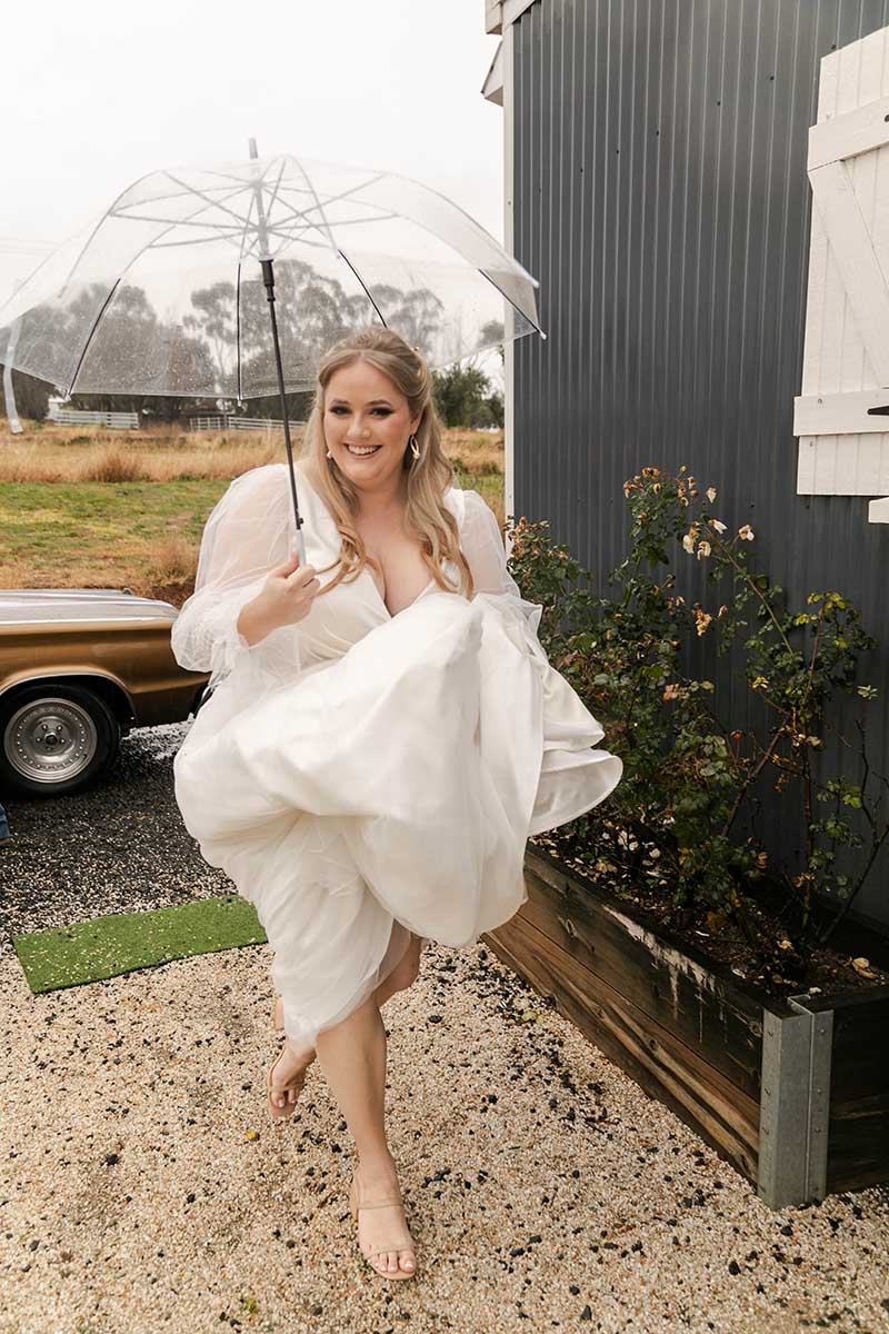 Wedding Photography - Bride walking in rain