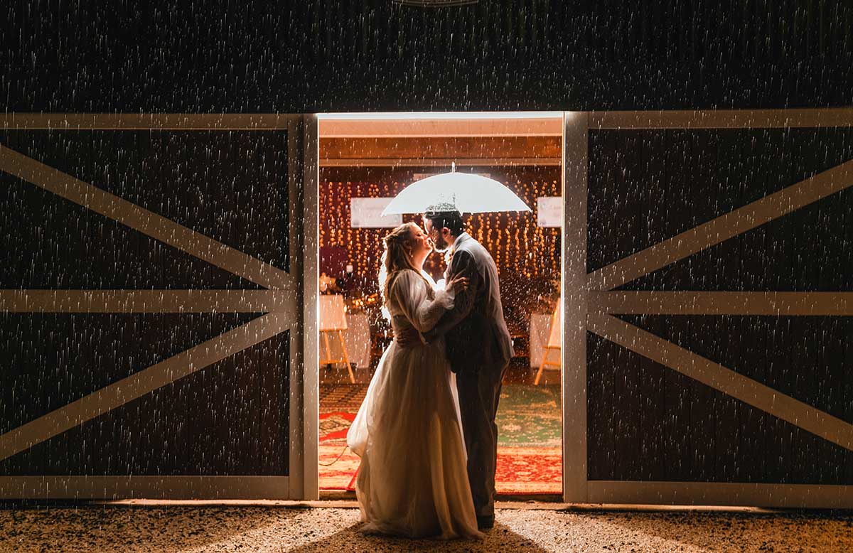 Wedding Photography - bride and groom in front of rustic barn door