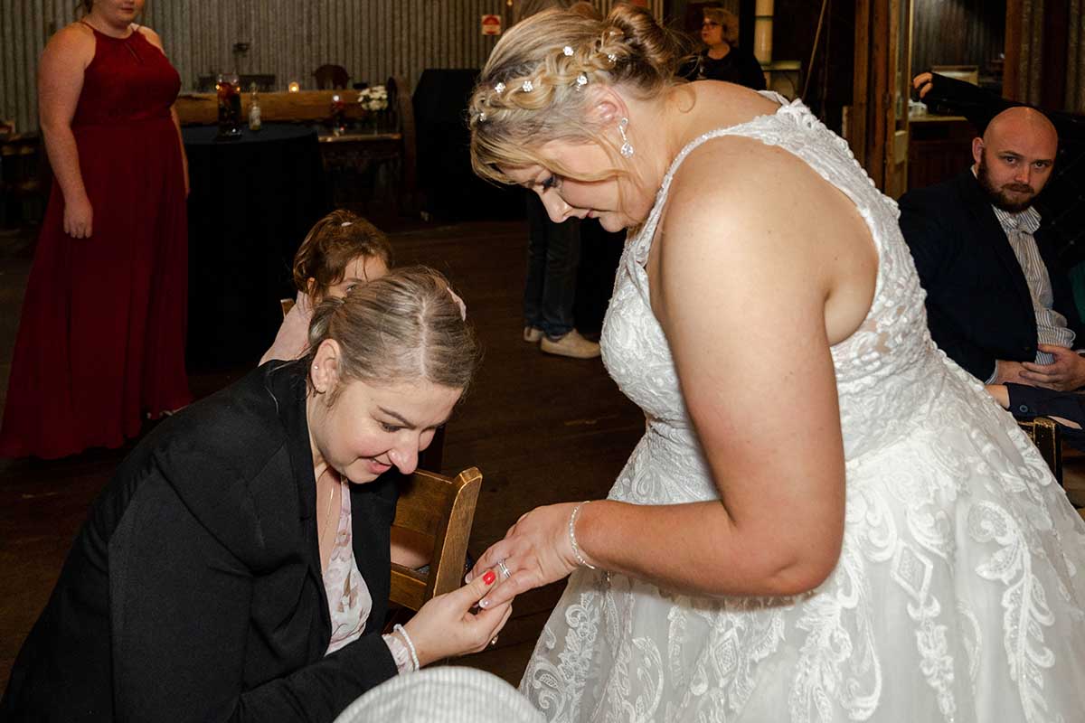 Wedding Photography - bride showing ring to guest