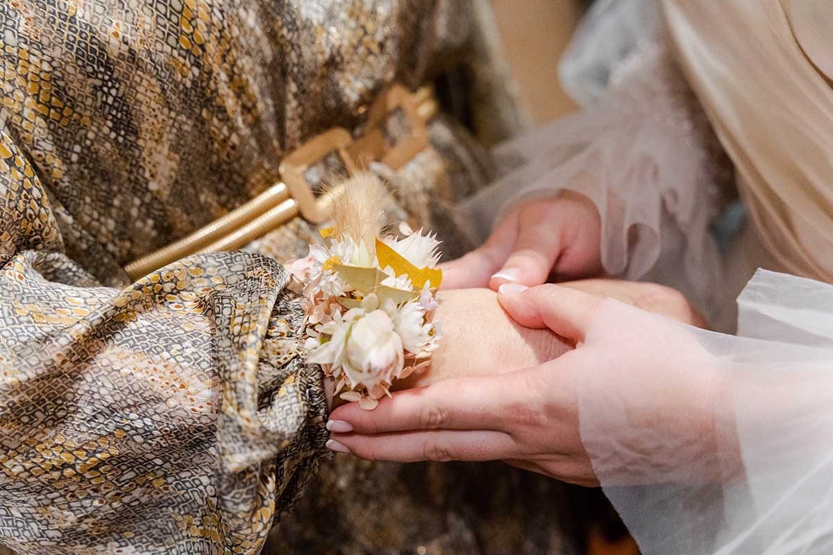 Wedding Photography - close up of bride holding guests hand