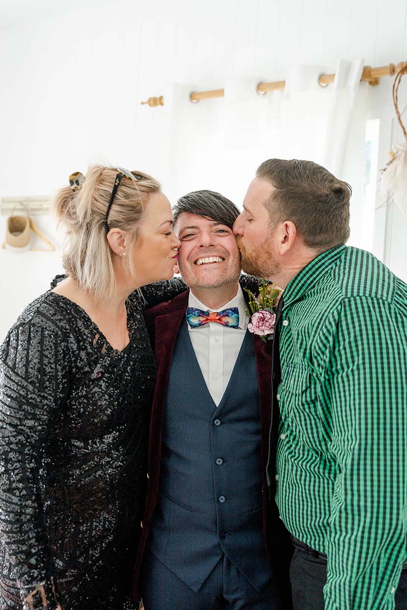Wedding Photography - groom receiving cheek kisses