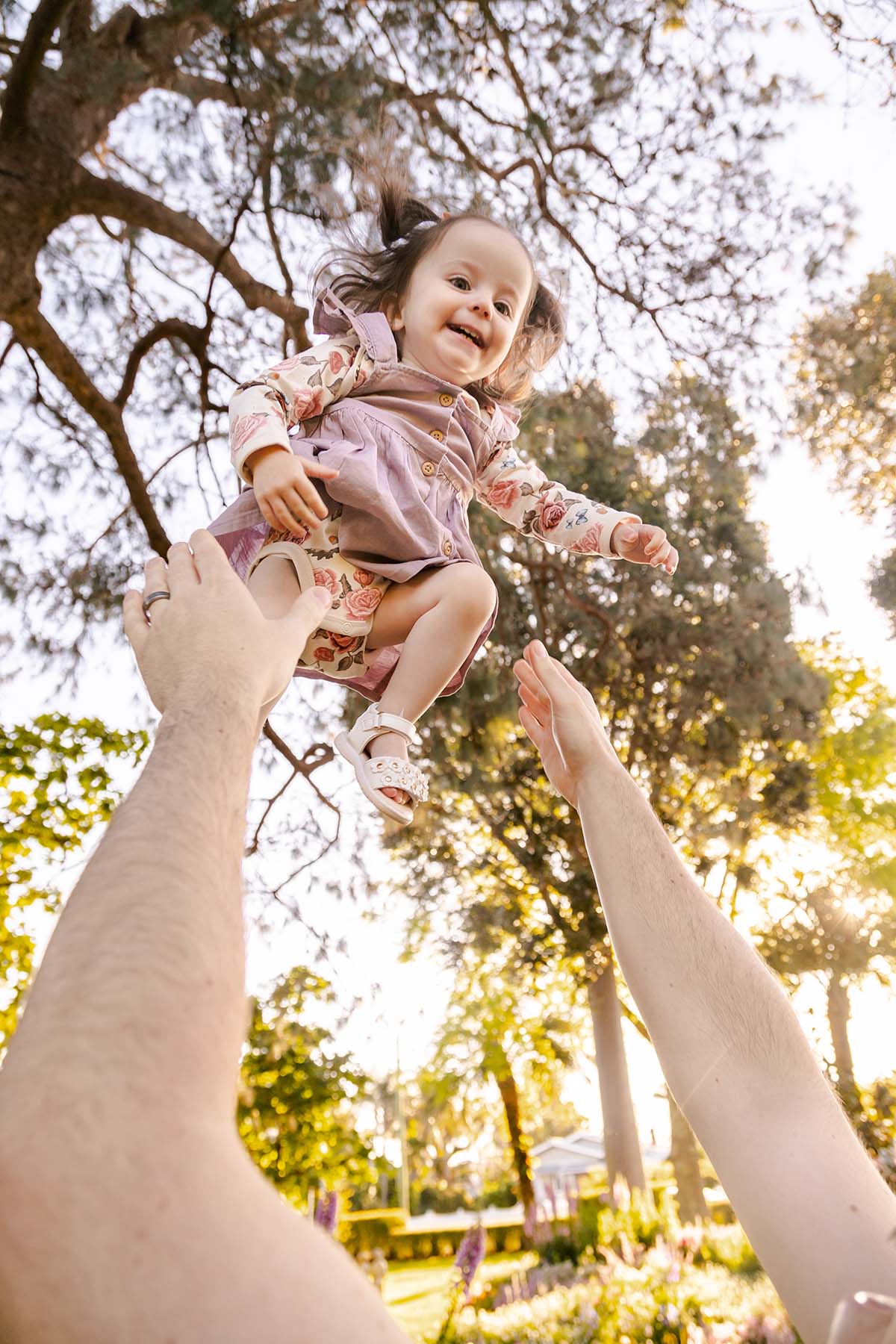 Family Photography - tossing young girl into air
