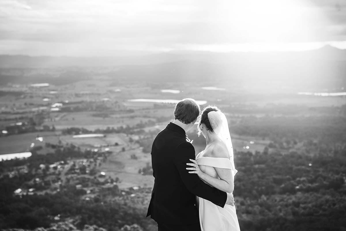 Wedding Photography - Bride and Groom overlooking landscape black and white