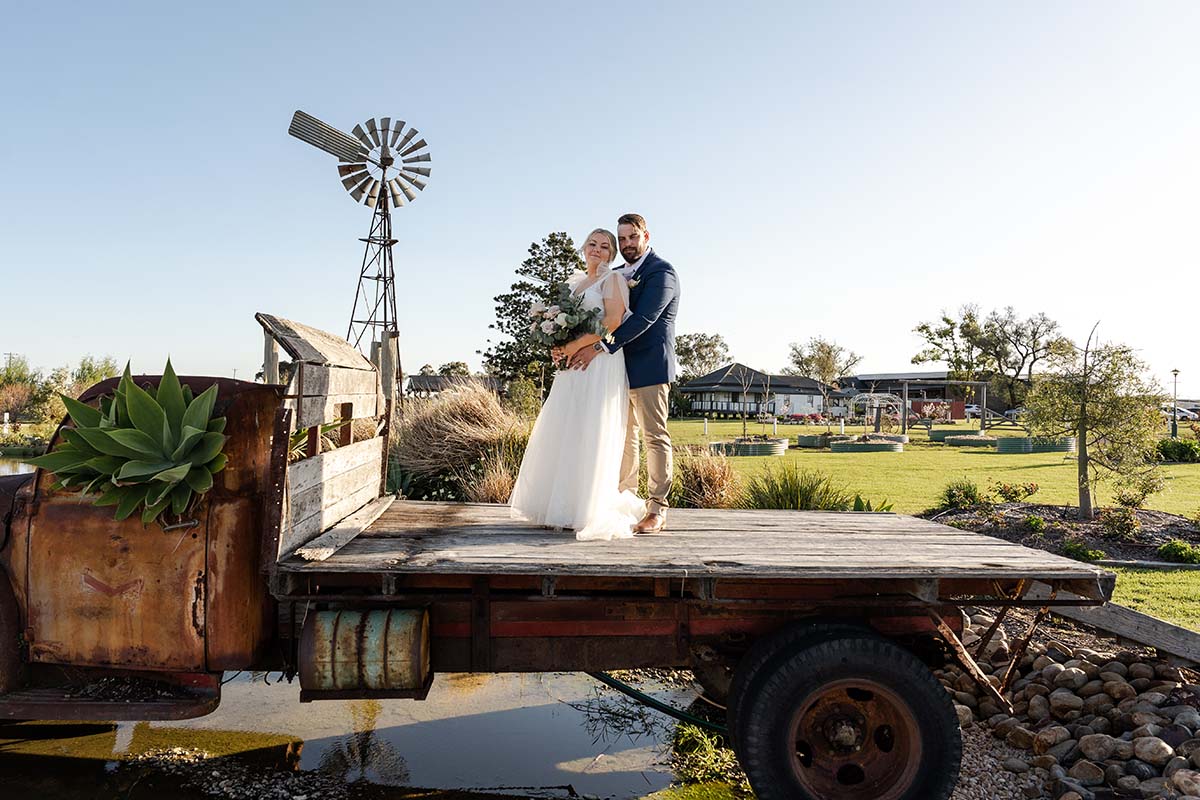 Wedding Photography - bride and groom on the back of an old truck