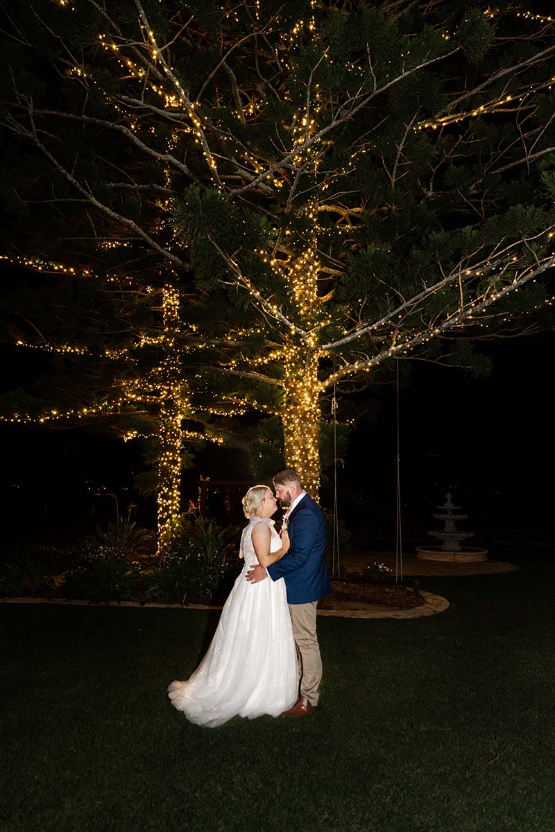 Wedding Photography - bride and groom under tree at night