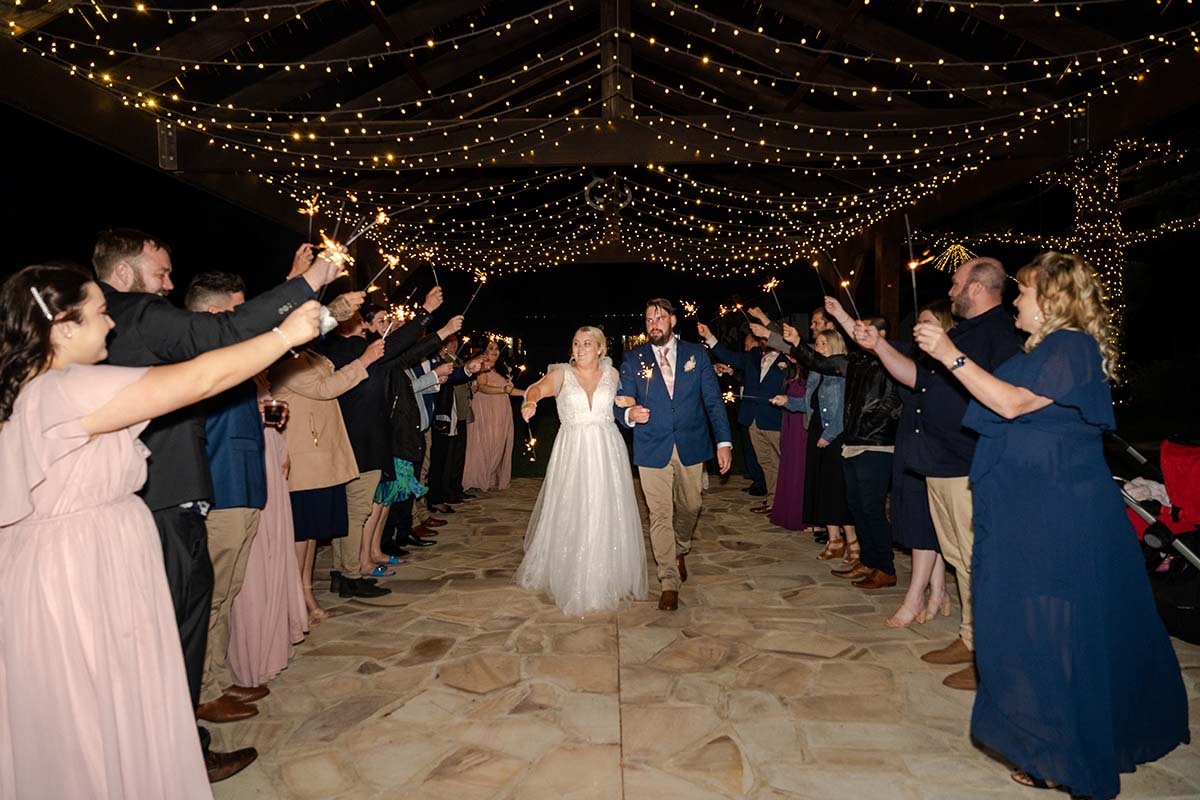 Wedding Photography – bride and groom walking under sparklers