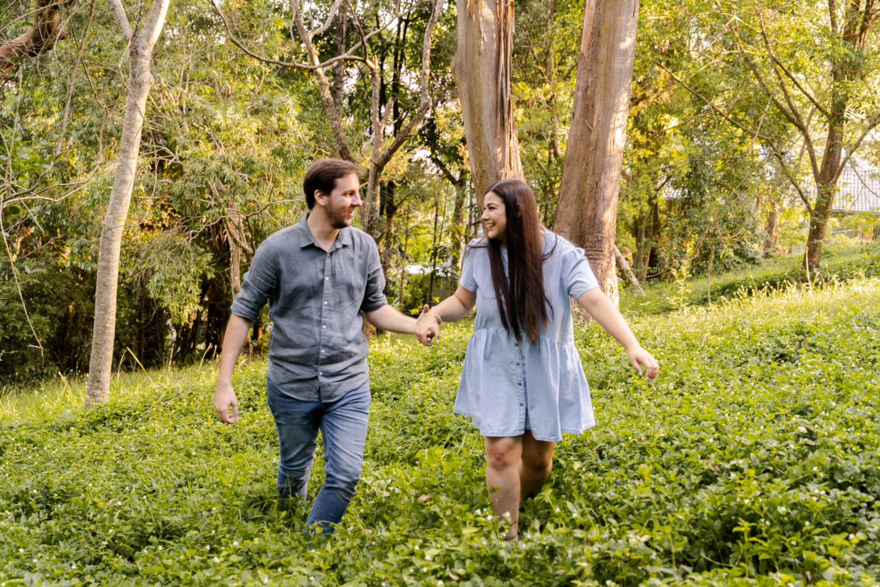 Engagement Photography - Couple holding hands in tall grass