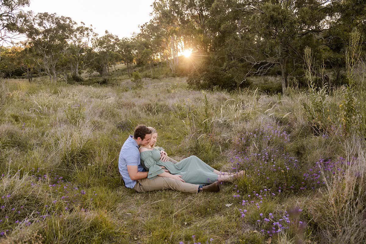 Maternity Photography - couple sitting in field