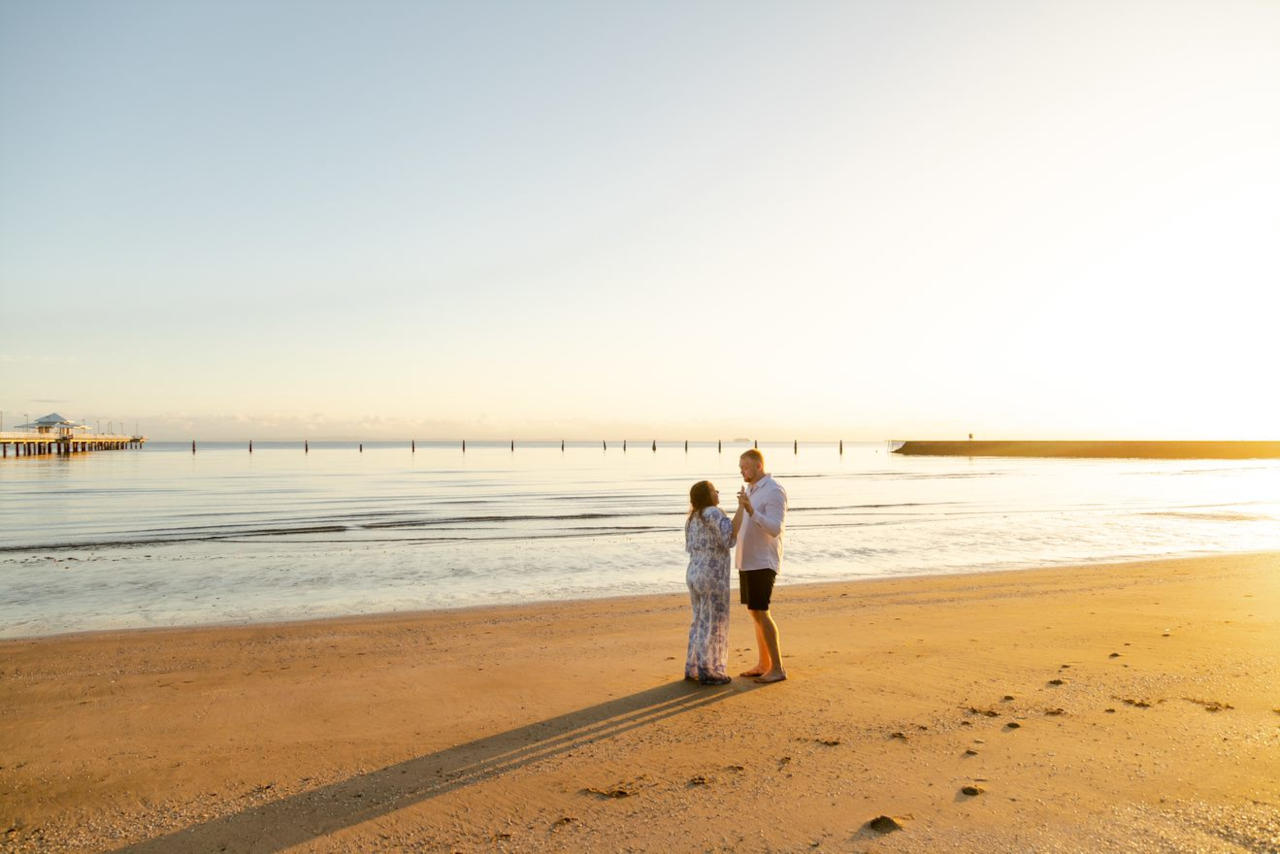 Engagement Photography - Sunrise Shorncliffe Pier - couple standing on shoreline