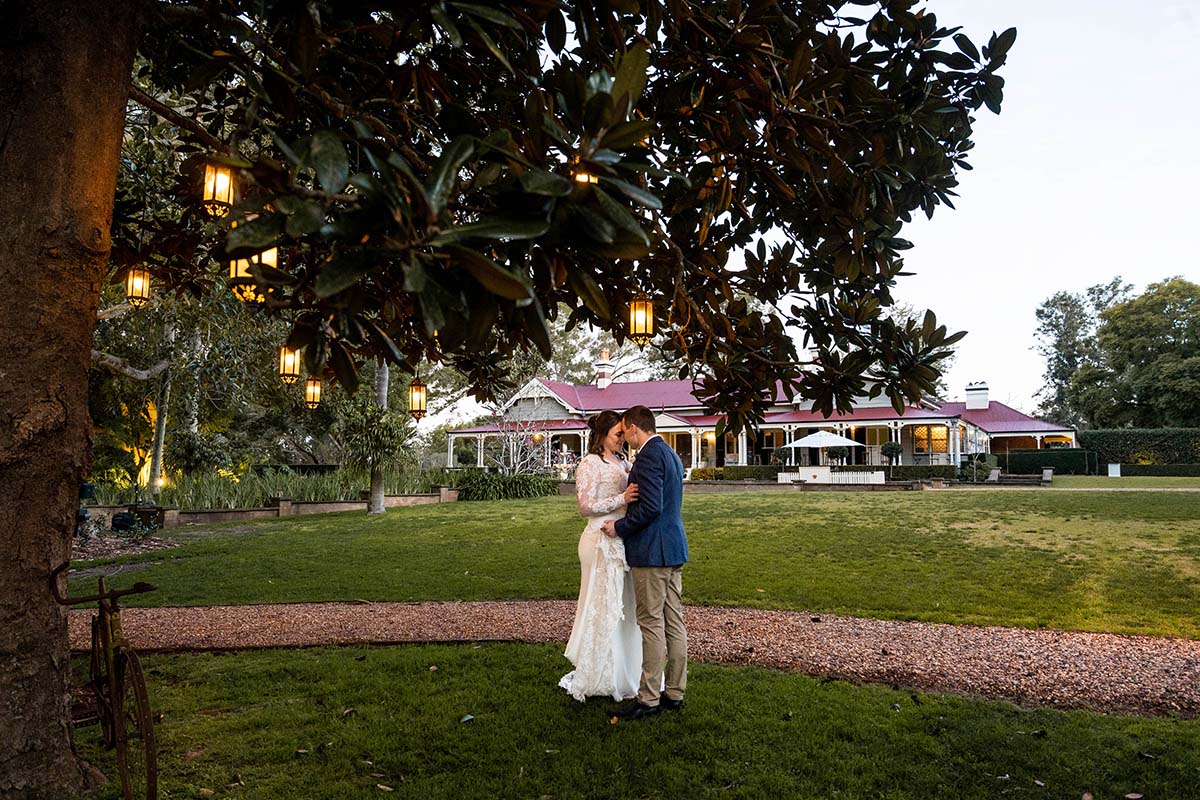 Wedding Photography - bride and groom embrace under tree