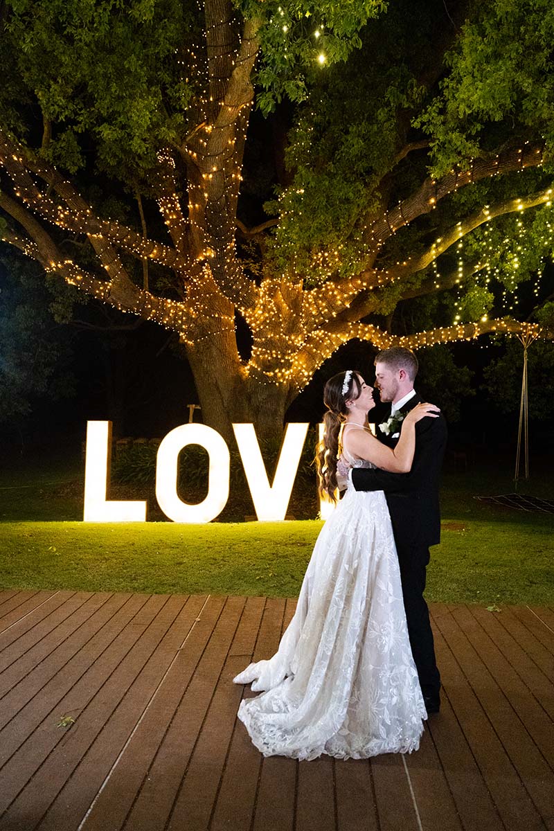 Wedding Photography -bride and groom in front of LOVE sign