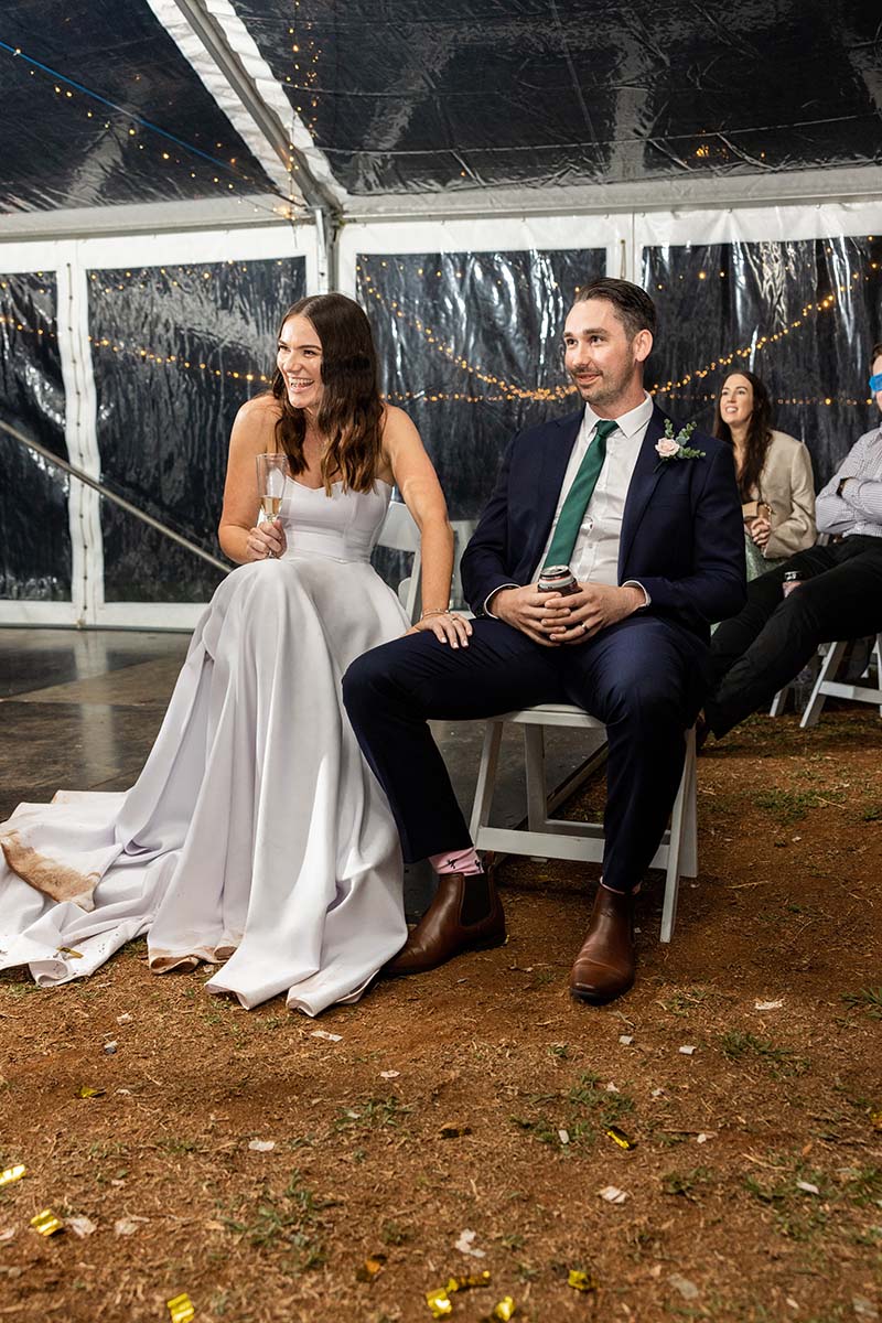 Wedding Photography - bride and groom sitting in chairs laughing