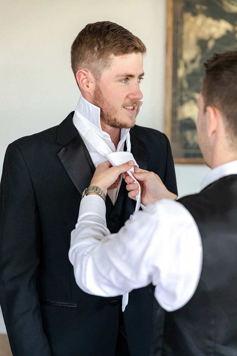 Wedding Photography – groom getting tie tied