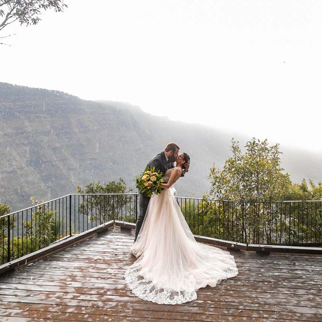 Lewis & Patricia O'Reillys Rainforest retreat Elopement - Newly wed kissing in the rain