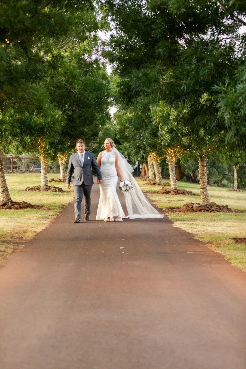 Preston Peak Wedding - Bride and Groom walking along a walkway - Nick and Aleisha