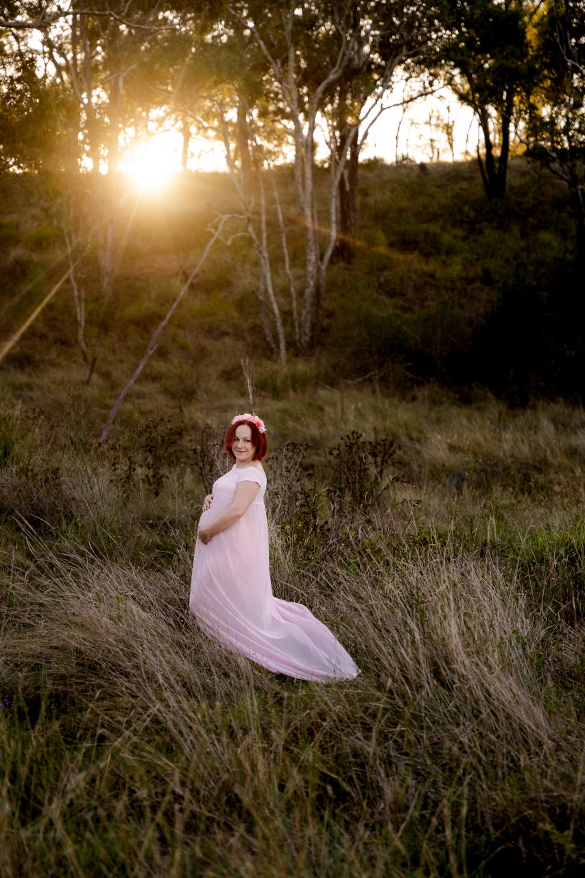 Maternity pics standing in a field