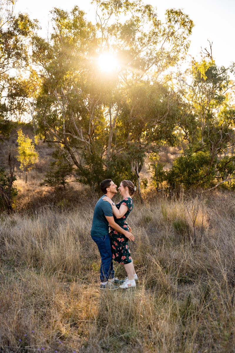 Engagement Photography couple holding each other in field