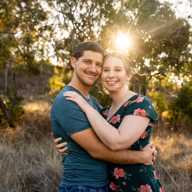 Engagement Photography couple in field at sunset