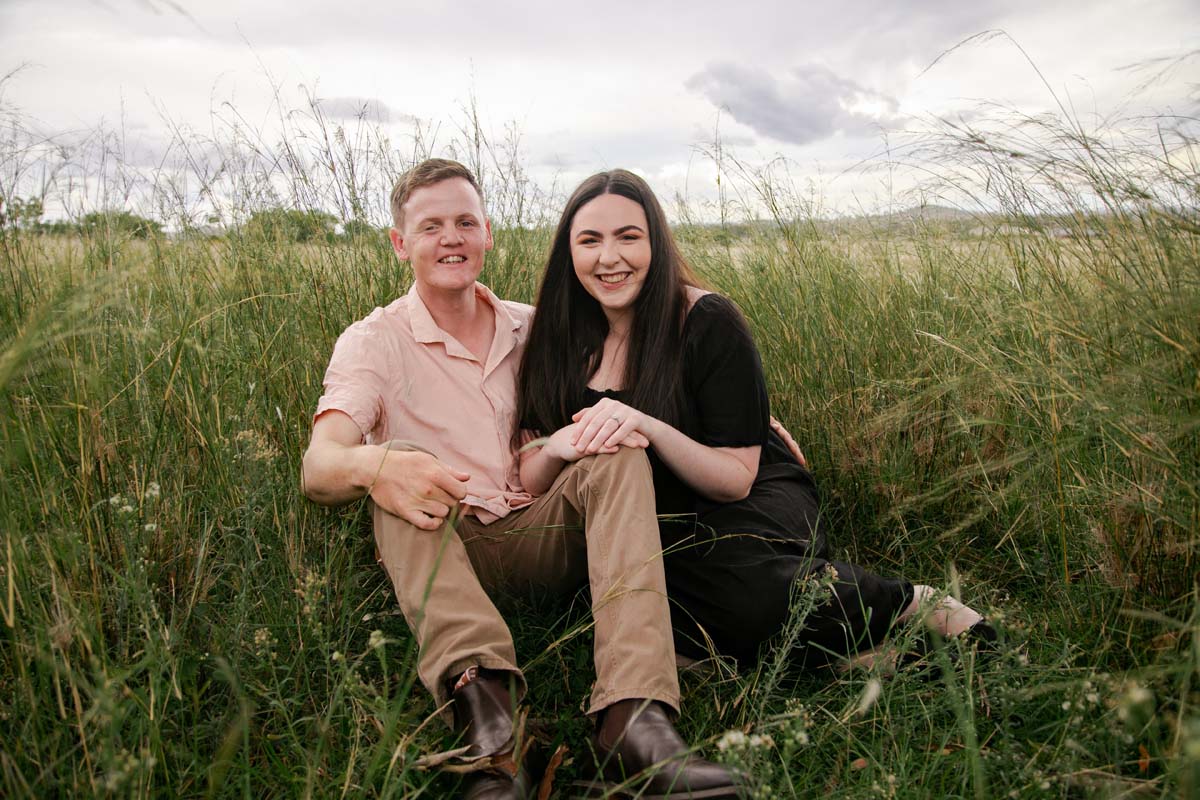 Engagement Photography couple sitting in field