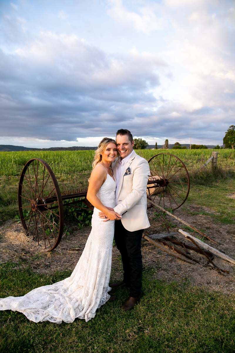Wedding Photography bride and groom in front of rustic plough