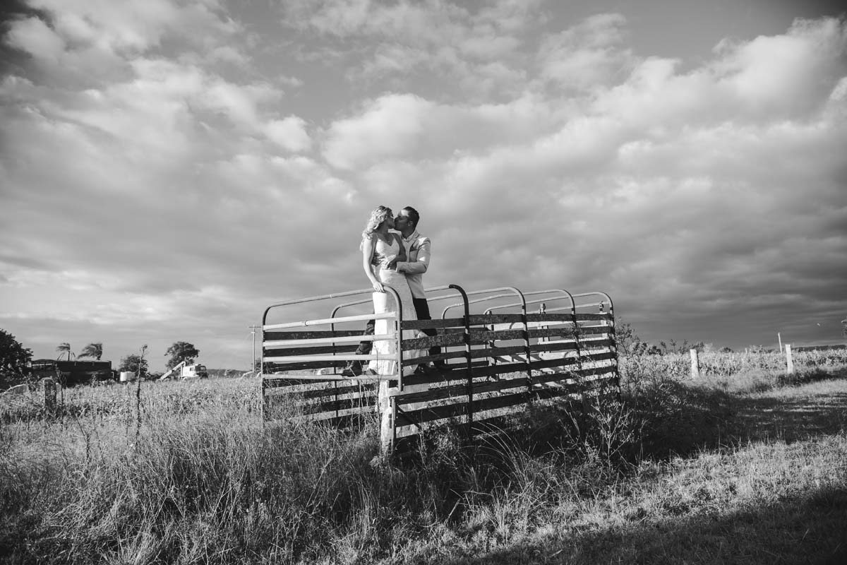 Wedding Photography bride and groom standing on cattle fencing